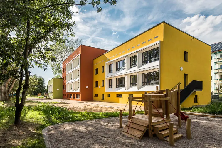 Hier spielen Kinder gerne: B&auml;ume spenden Schatten auf der S&uuml;dseite der sanierten Kindertagesst&auml;tte